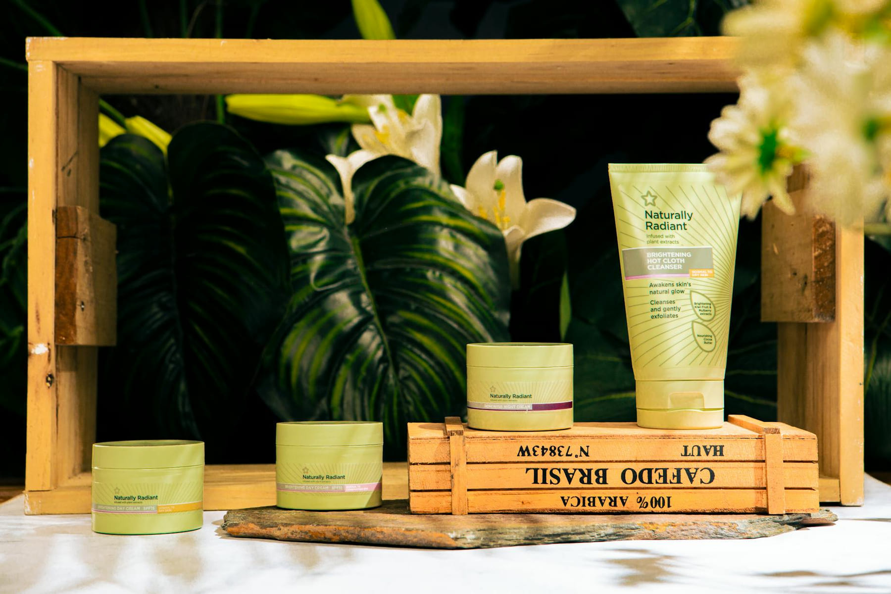 Skincare products showcased among lush greenery with a natural radiant theme. on Purely Polished