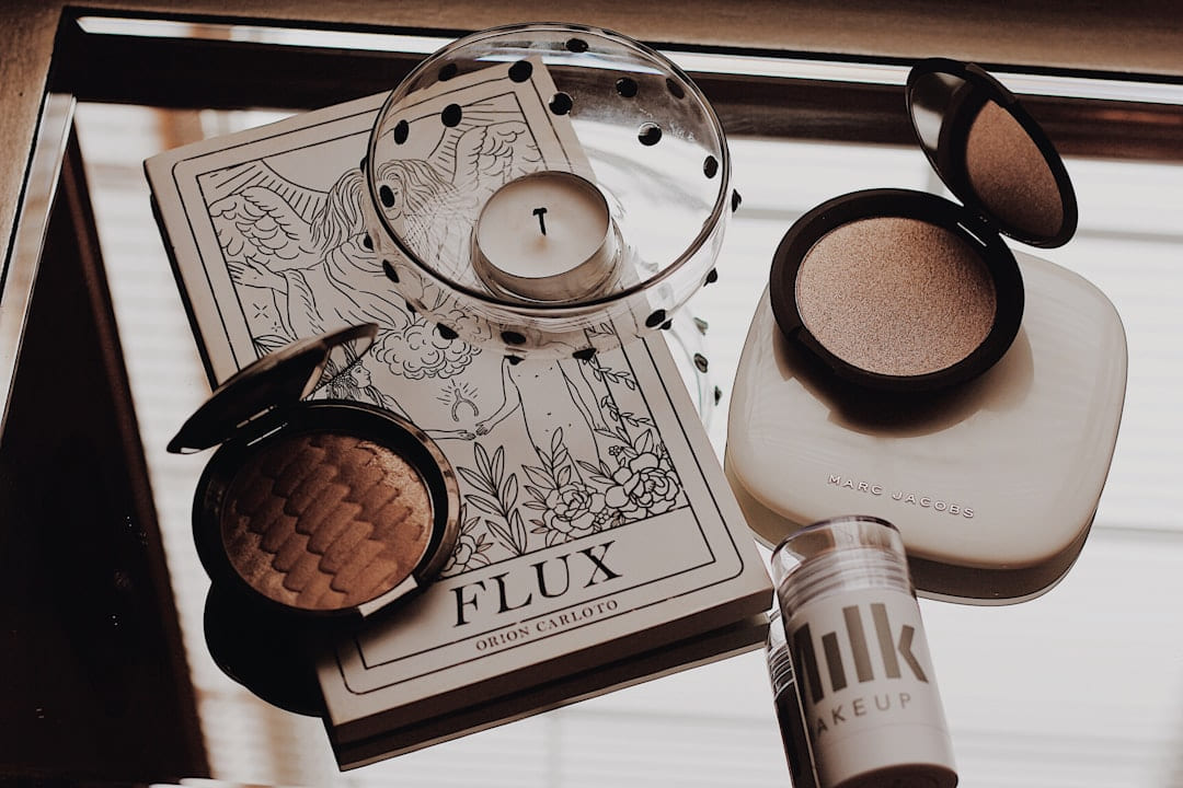white tealight candle beside makeup palette on Purely Polished