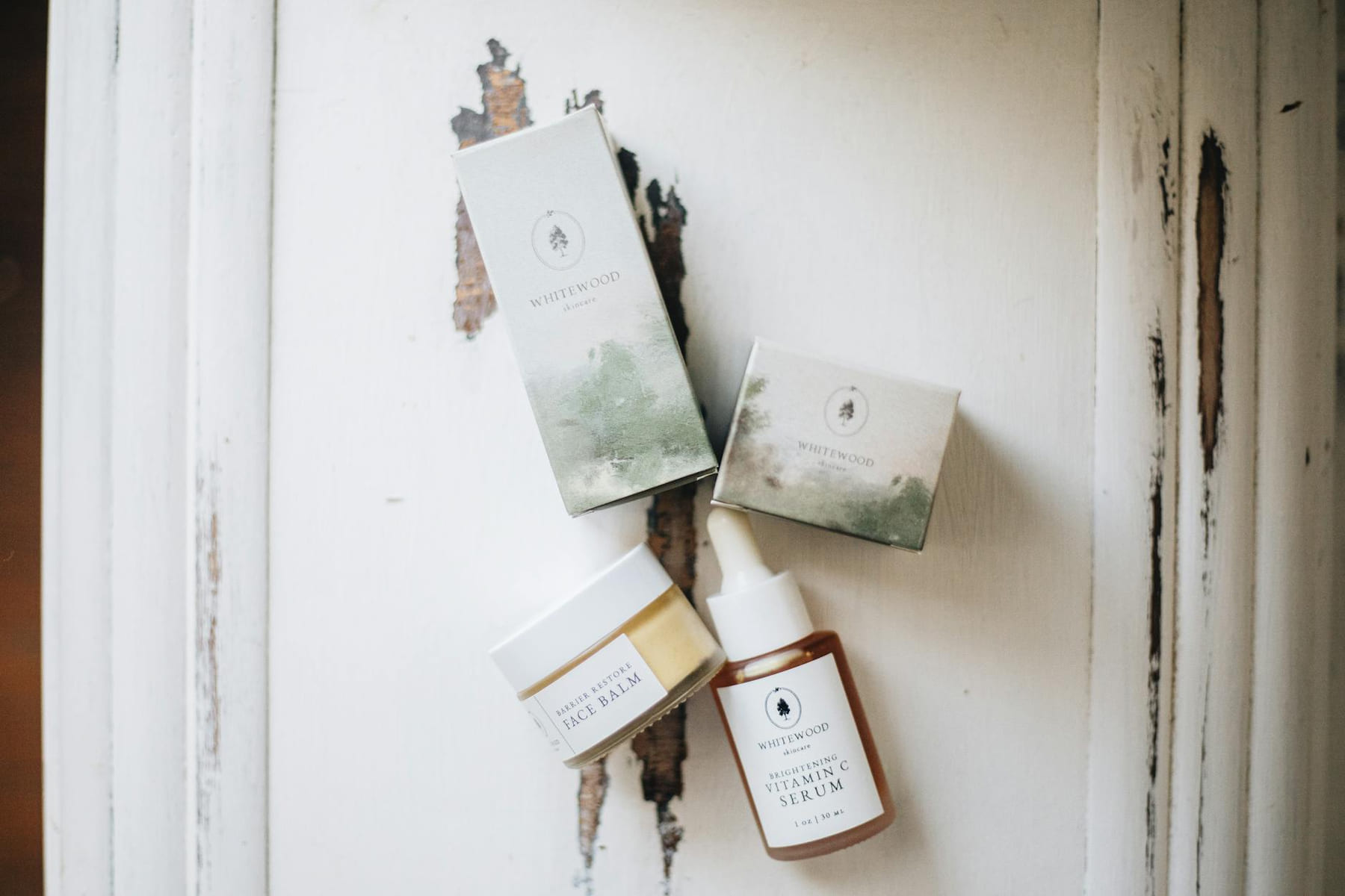 Flat lay of organic skincare items on a rustic surface, emphasizing natural beauty and minimalism. on Purely Polished